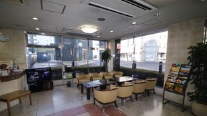 A restaurant with a counter, seating area, and a menu board. - Hotel Green Line (Sendai)