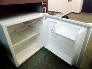 An open refrigerator with a control panel on the right side and a shelf on the left. - Hotel Green Line (Sendai)