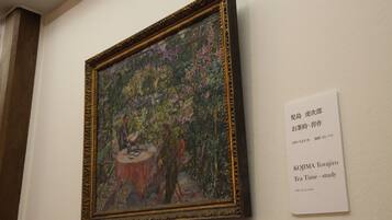 A framed painting with a descriptive label beside it.