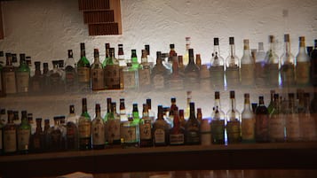 A bar with various bottles of liquor on shelves.