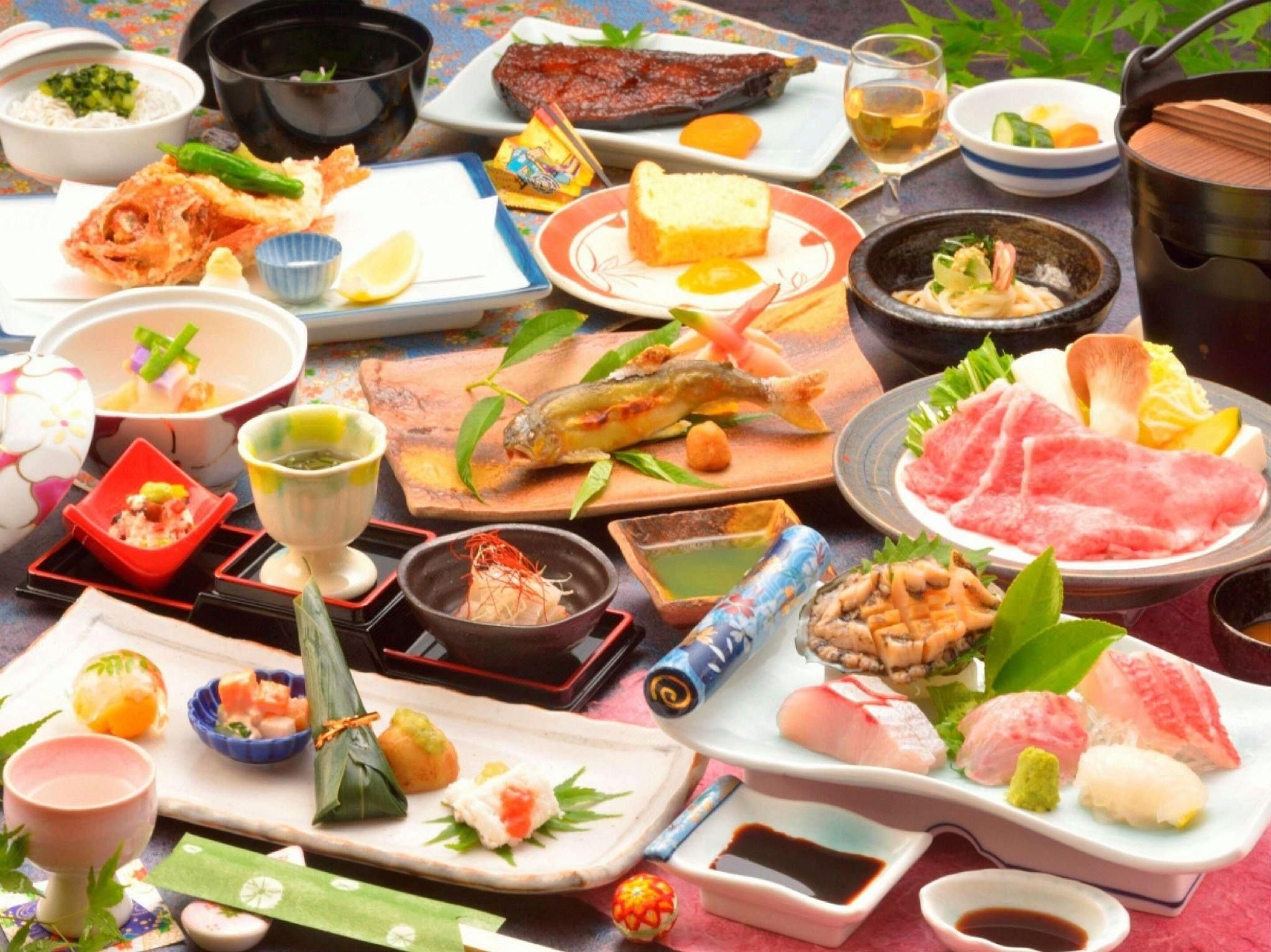 A variety of Japanese dishes and drinks on a table.
