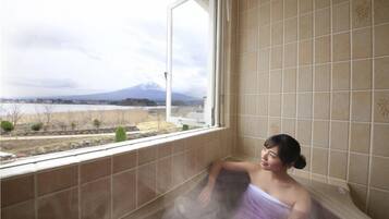 Enjoy breathtaking views of the distant mountain and water from this room's large window.