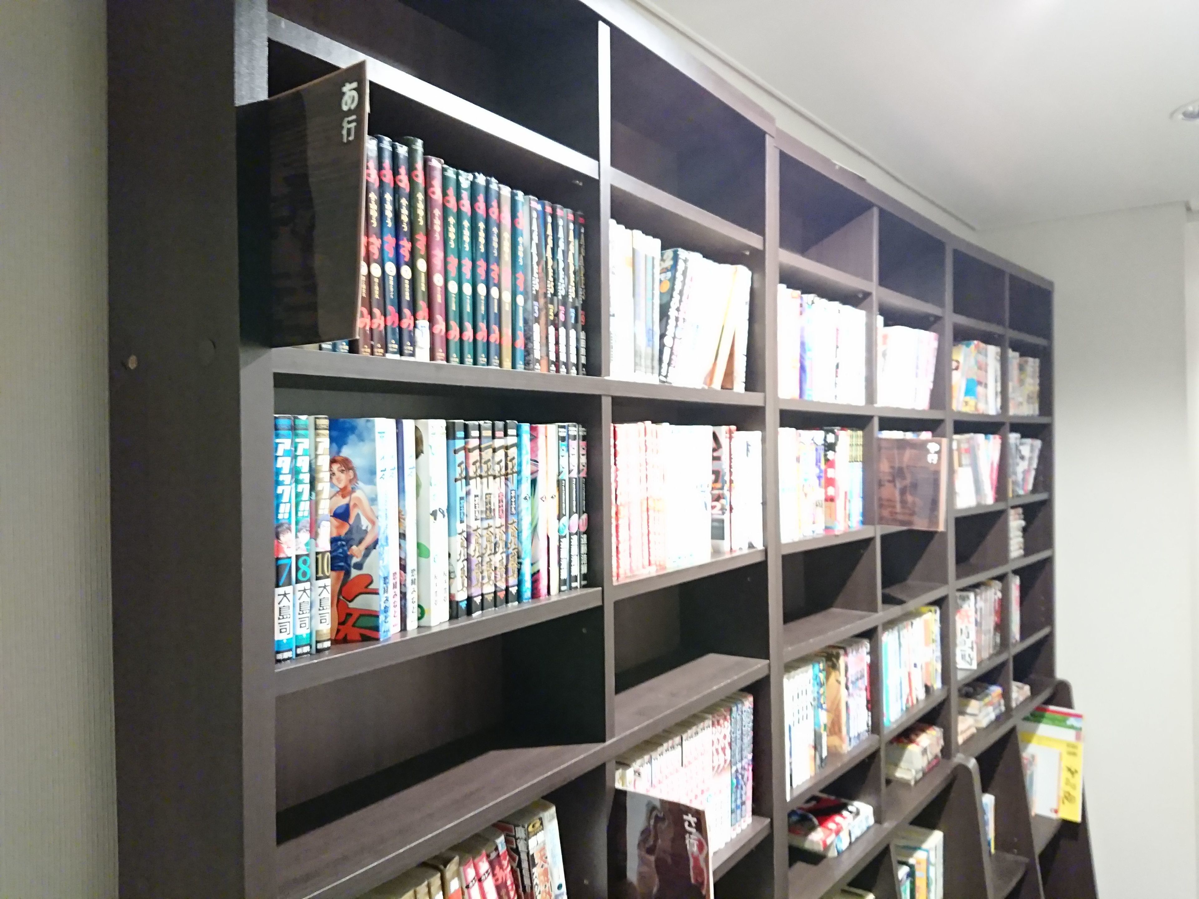 A bookshelf filled with books and DVDs.