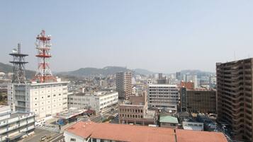 A cityscape with various buildings, including a prominent tower with antennas.