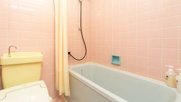 A bathroom with a bathtub, toilet, and sink.