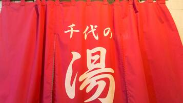 Cortina roja con caracteres japoneses blancos.