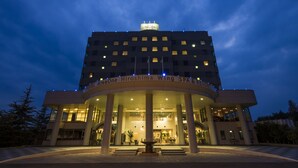 A hotel with a modern design, featuring a prominent entrance and multiple floors. - Hotel AreaOne Hiroshima Wing (Higashihiroshima)