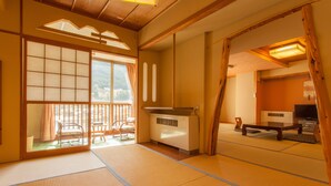 A traditional Japanese room with tatami flooring, sliding doors, a futon bed, a heater, and a television. - Gero Onsen Okudaya Happoen (Gero)