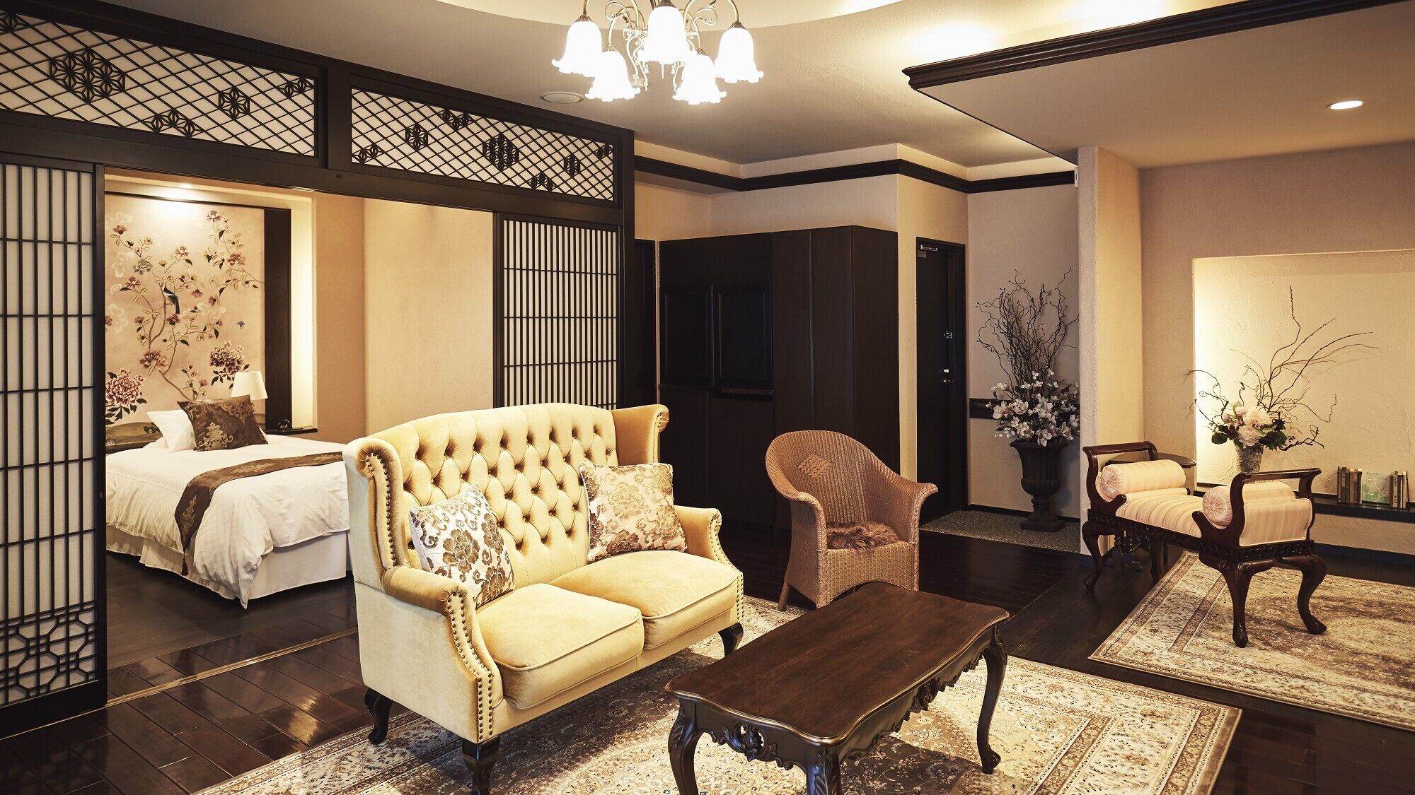 A traditional Japanese-style room with tatami flooring, a low sofa, a wooden coffee table, and a sliding door.