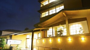 A multi-story building with illuminated windows and a signboard. - Tokiwaya (Numazu)