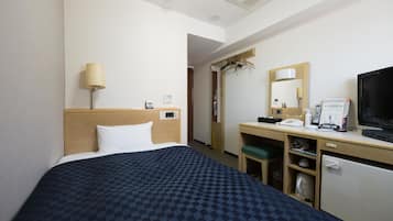 A hotel room with a bed, a desk with a chair, a television, a mirror, and a small refrigerator.