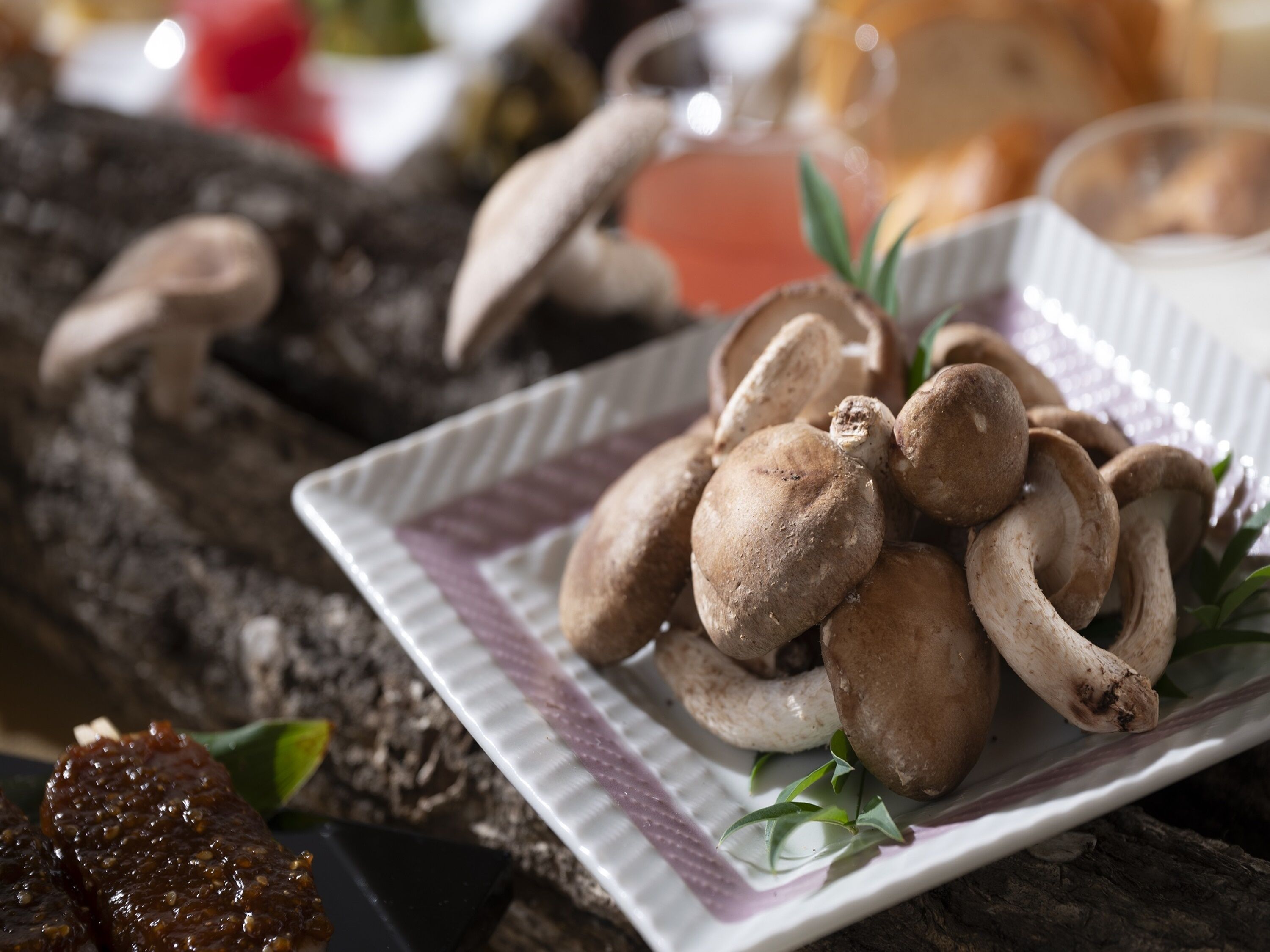 A plate of mushrooms on a textured tablecloth.