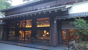 A traditional Japanese building with a modern entrance, large glass doors, and a well-lit interior. - Kashiwaya (Nikko)