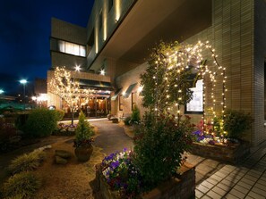 A restaurant with a modern exterior, outdoor seating, and decorative lighting. - Chres (Kochi)