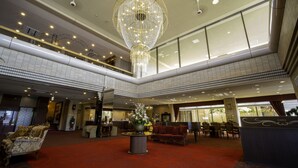 A spacious lobby with a grand chandelier, comfortable seating, and a high ceiling. - Chres (Kochi)