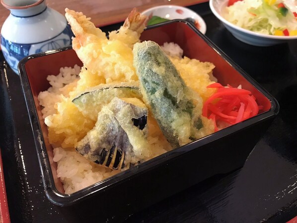 A black tray with tempura shrimp and vegetables over rice. - Kawaguchi Onsen Ousanso (Akita)