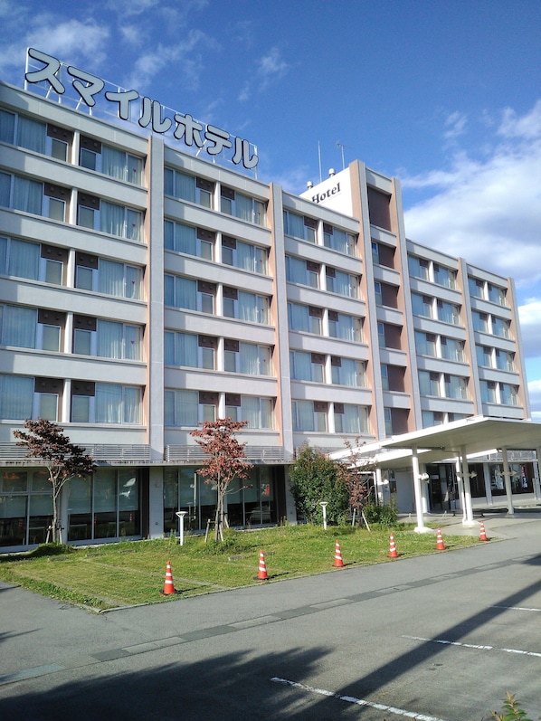 A multi-story hotel building with a sign indicating it is a hotel.