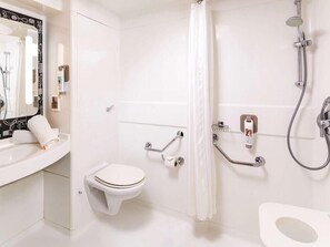 A modern bathroom with a white sink, toilet, and shower. - Ibis London Wembley (London)