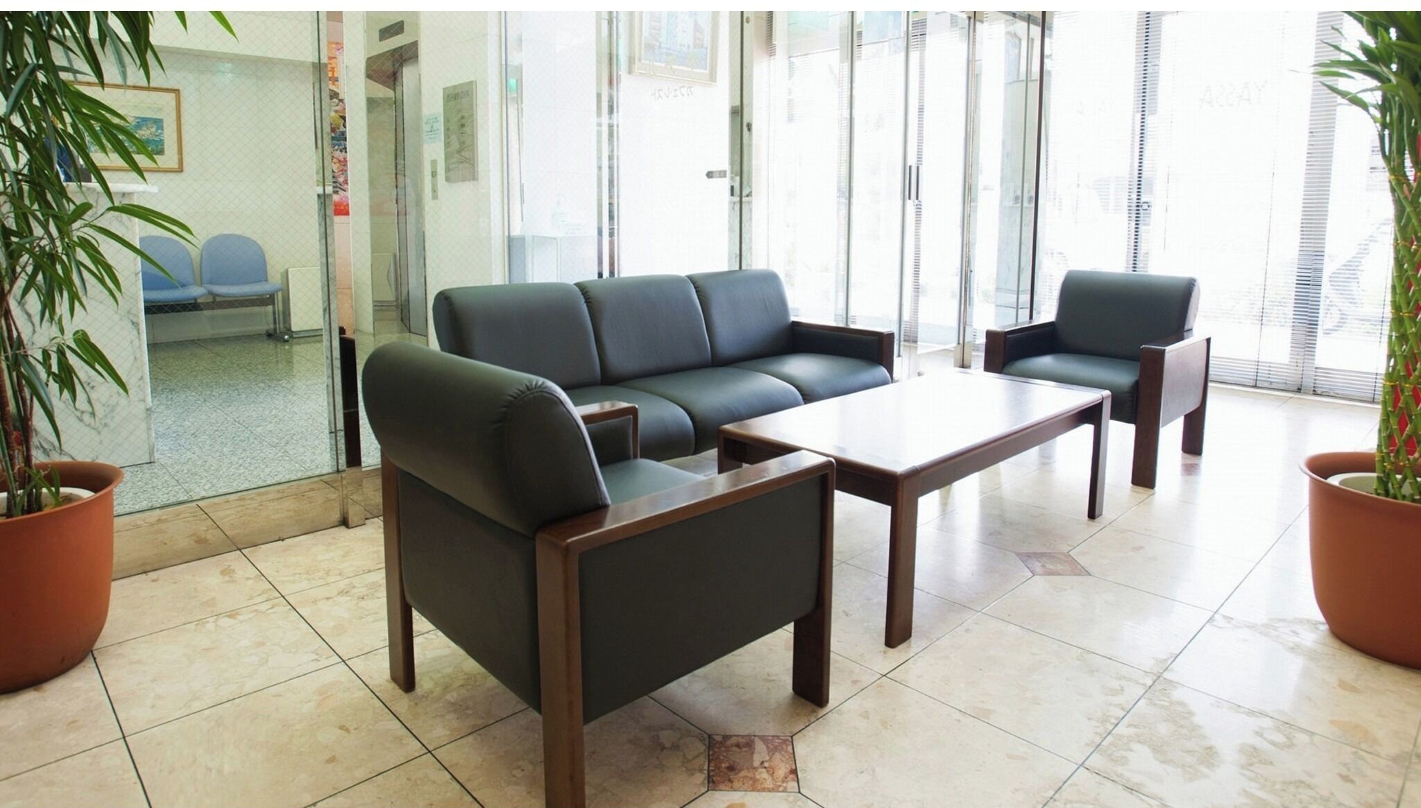 A modern waiting area with a sofa, chairs, and a coffee table.