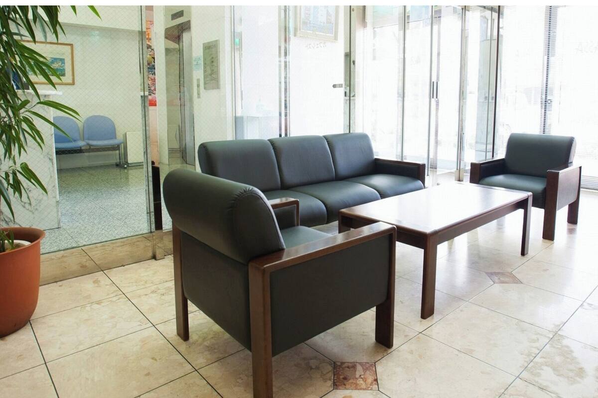 A modern waiting area with a sofa, chairs, and a coffee table.