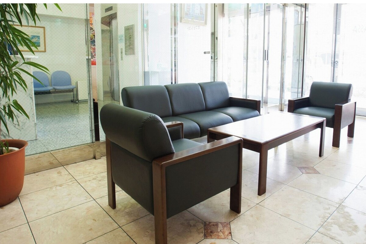 A modern waiting area with a sofa, chairs, and a coffee table.