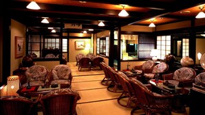 A traditional Japanese-style room with tatami flooring, wooden furniture, and shoji screens. - Hana No Omotenashi Nanraku (Minamiizu)