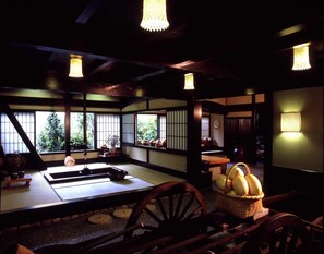 A traditional Japanese room with tatami flooring, shoji screens, and a low table with a woven basket. - Hana No Omotenashi Nanraku (Minamiizu)