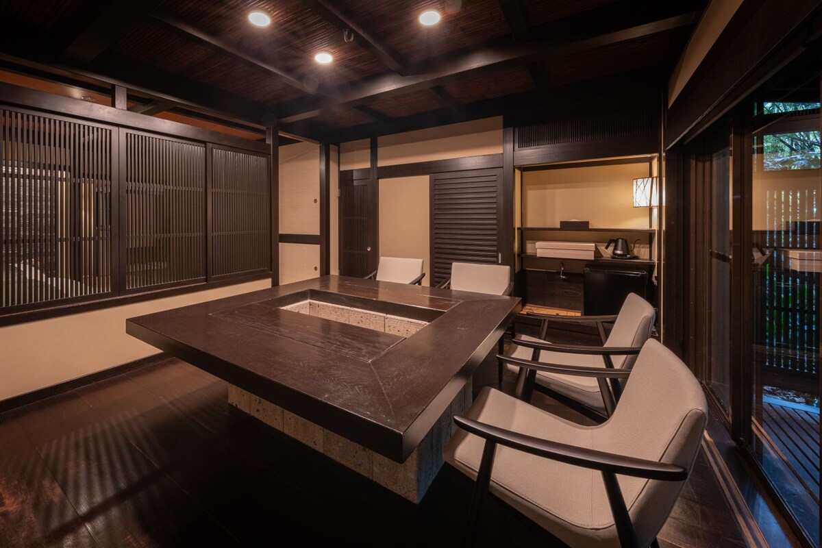 A conference room with a large table, chairs, and a wooden ceiling.
