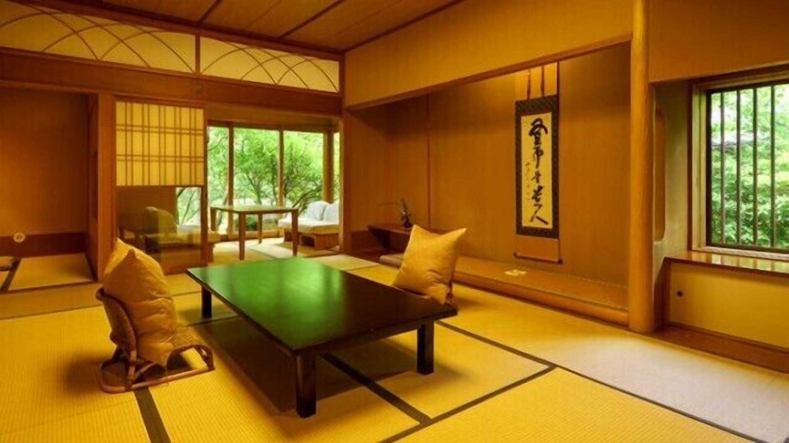 A traditional Japanese room with tatami flooring, a low table, cushions, and a sliding door leading to a garden.