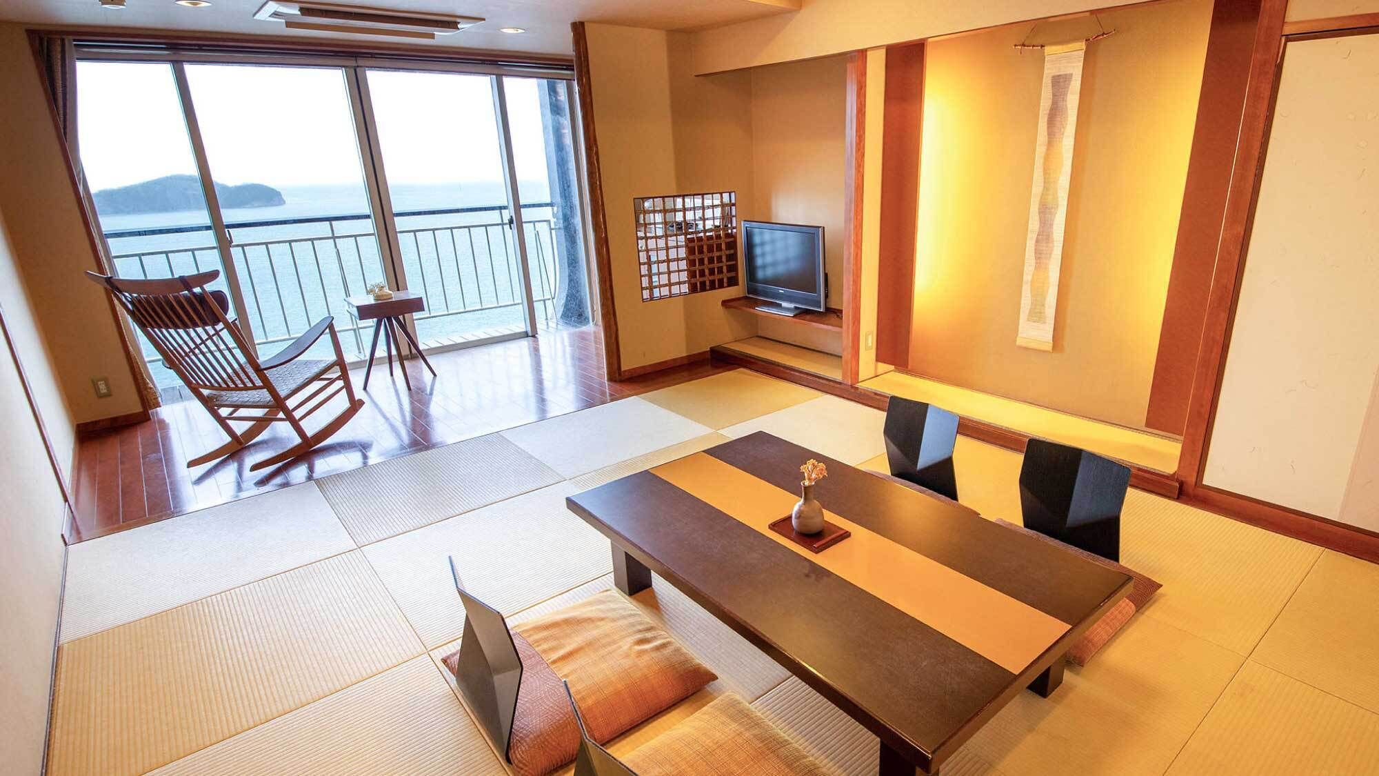 Una habitación con un ventanal grande, televisor, mesa de comedor y una zona de estar con sillas.