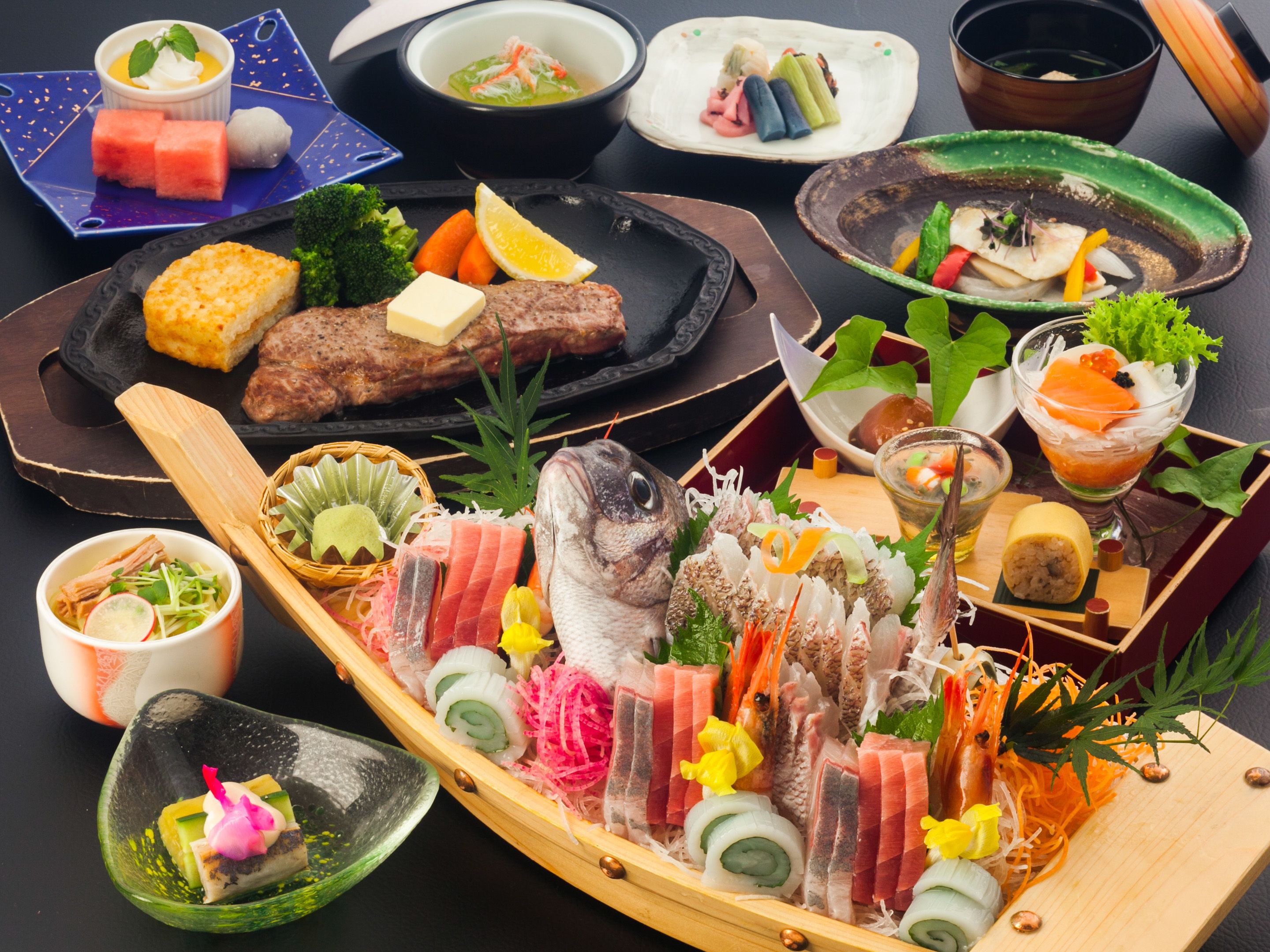A variety of Japanese dishes including sushi, sashimi, and grilled meats, arranged on a wooden tray.