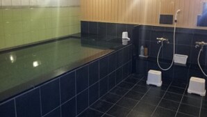 Une salle de bain avec une grande baignoire, un espace douche et des toilettes.
