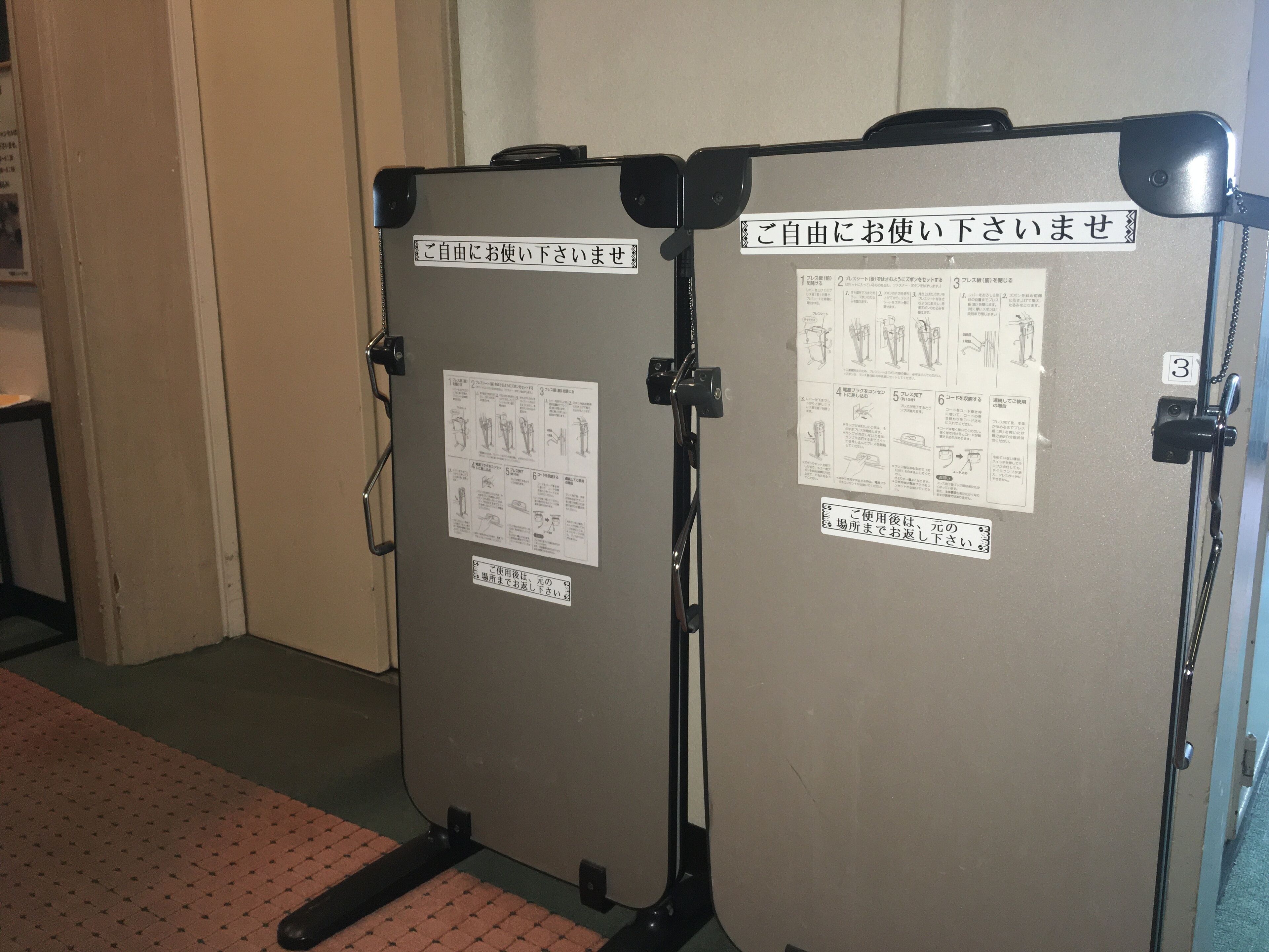 Two portable toilets with instructions and a sign indicating they are for use by guests.