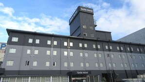 A multi-story building with a sign reading "Smile Hotel" on the top. - Smile Hotel Hachinohe (Hachinohe)
