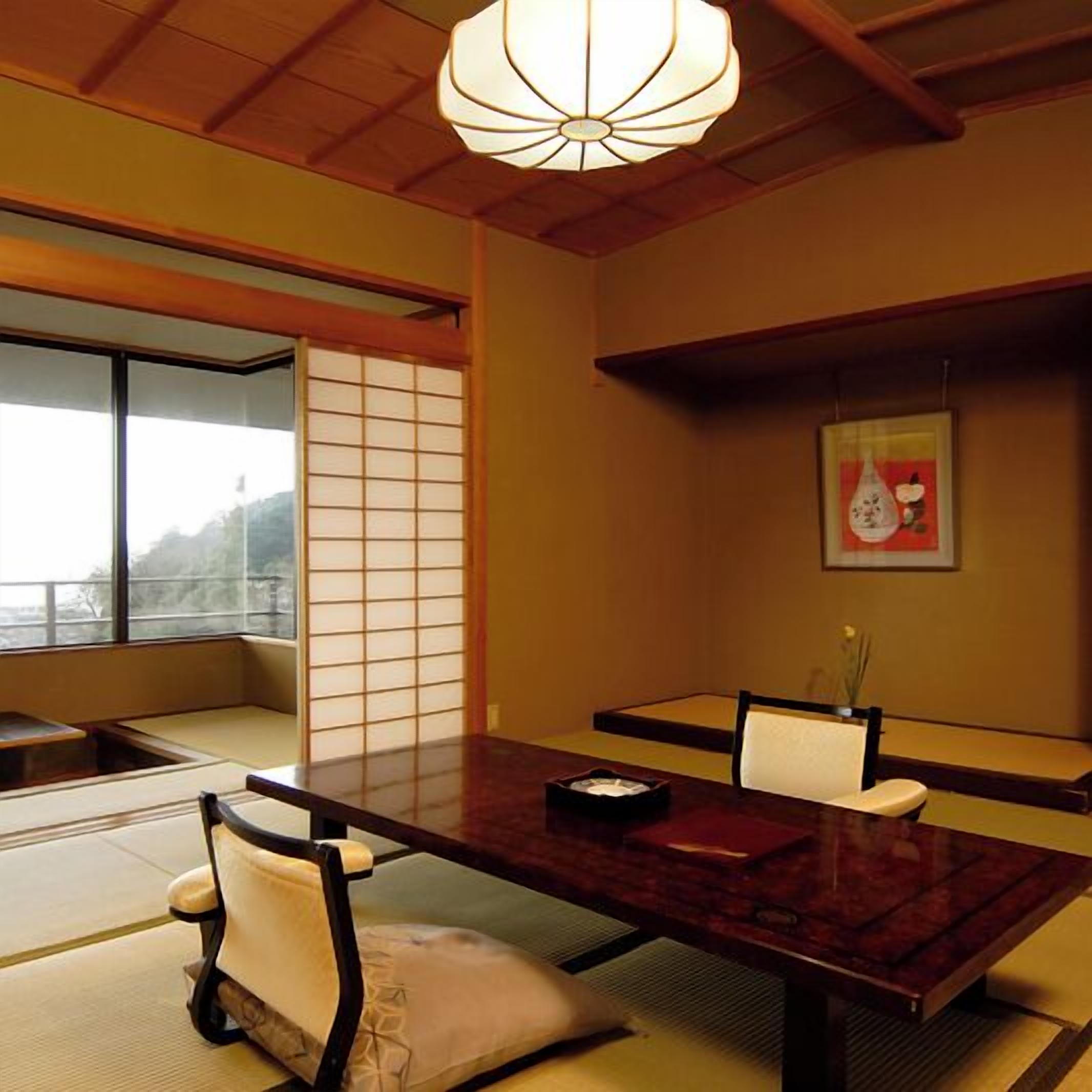 A traditional Japanese room with tatami flooring, a low table, and a shoji screen.