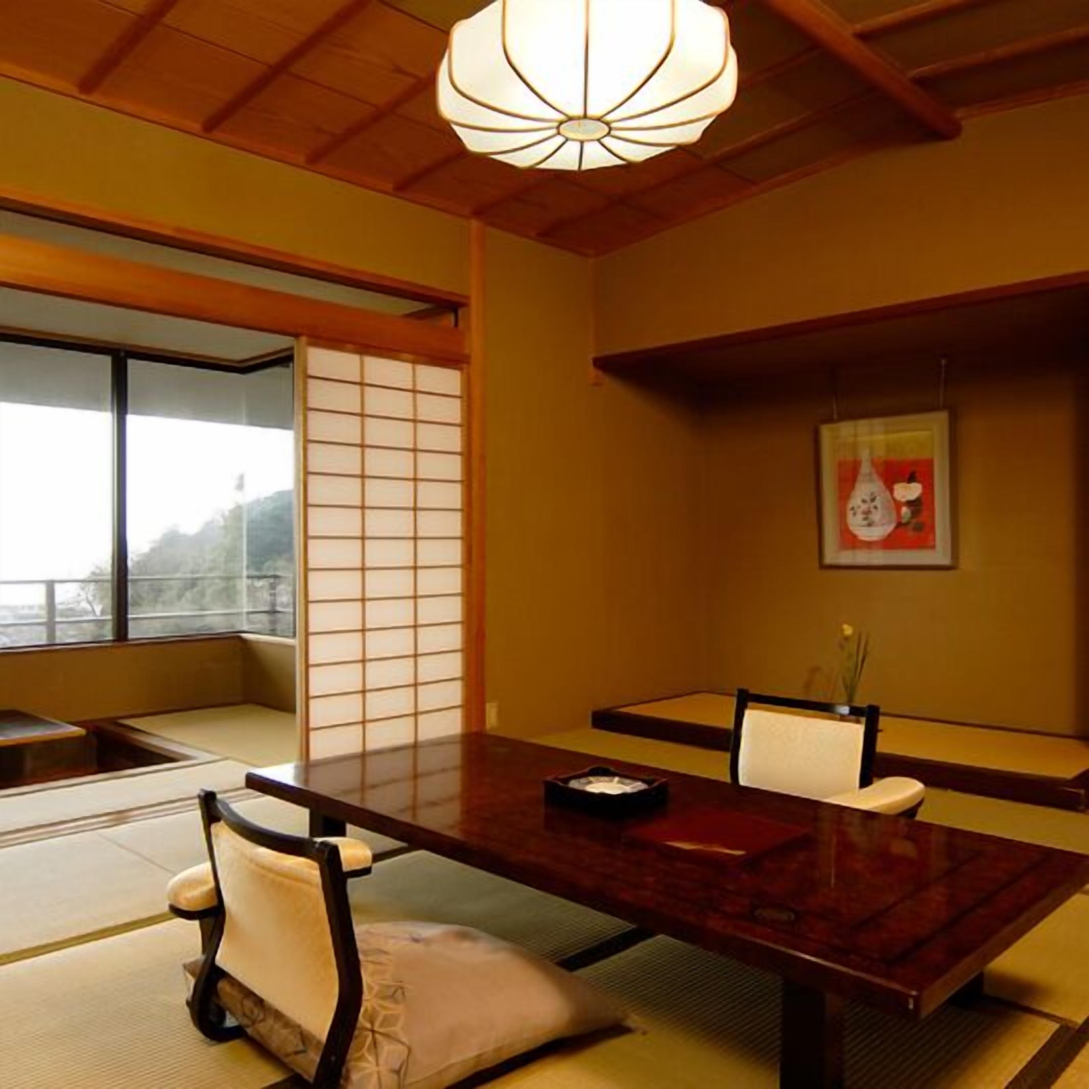 A traditional Japanese room with tatami flooring, a low wooden table, and a shoji screen.