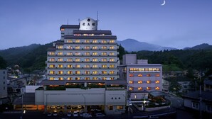 A multi-story hotel with a modern design, featuring a rooftop terrace and multiple balconies. - Aishinkan (Morioka)