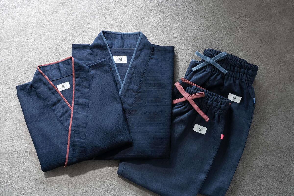 A pair of dark blue pants with a drawstring and a label marked 'M'.