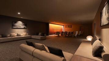 A modern living room with a sectional sofa, a coffee table, and a dining area with chairs.
