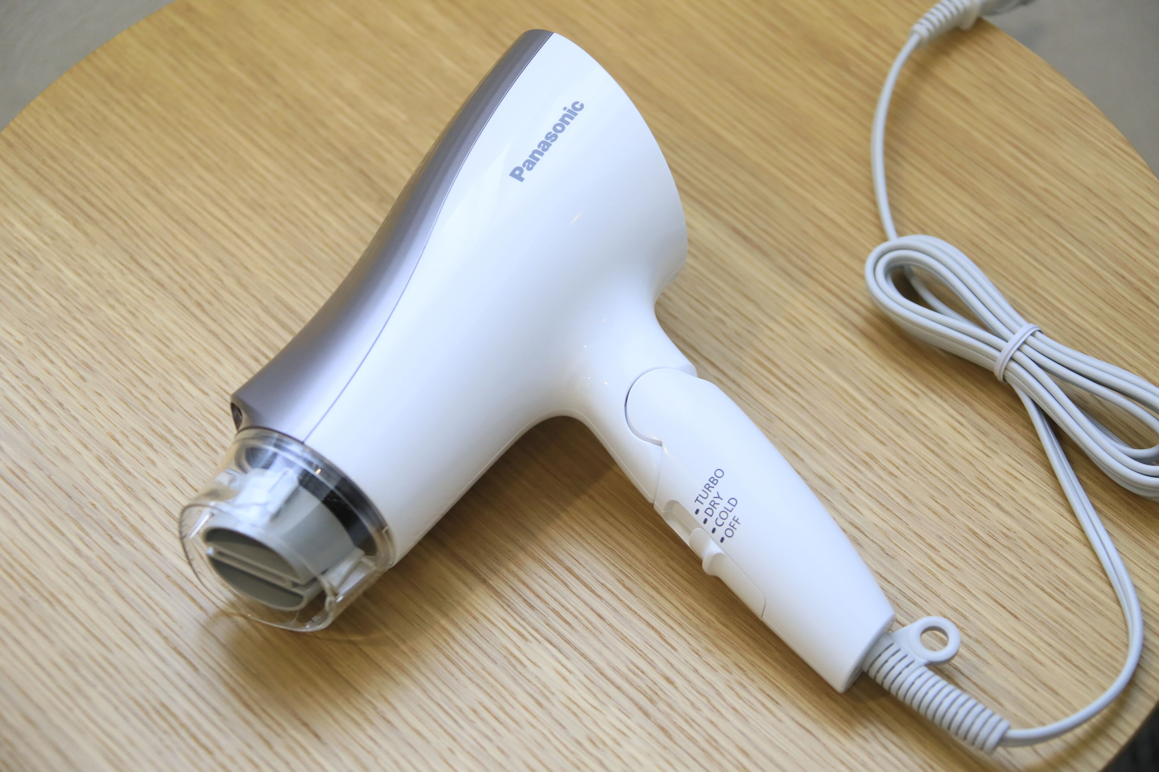 Um secador de cabelo Panasonic sobre uma superfície de madeira.
