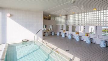 Enjoy a refreshing swim in our spacious pool area, featuring multiple shower stalls and a clean, uncluttered environment.