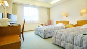 A hotel room with two beds, a desk with a telephone, a chair, a TV, and a window with curtains. - New Royal Hotel Shimanto (Shimanto)