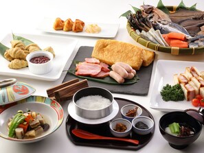 A variety of dishes including sushi, sashimi, and a bowl of rice. - Hotel Angel Grandia (Yuzawa)