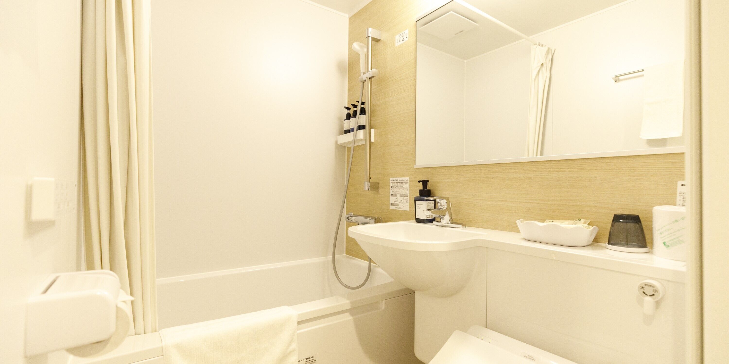 Un bagno moderno con una vasca, un lavandino, uno specchio e una doccia.