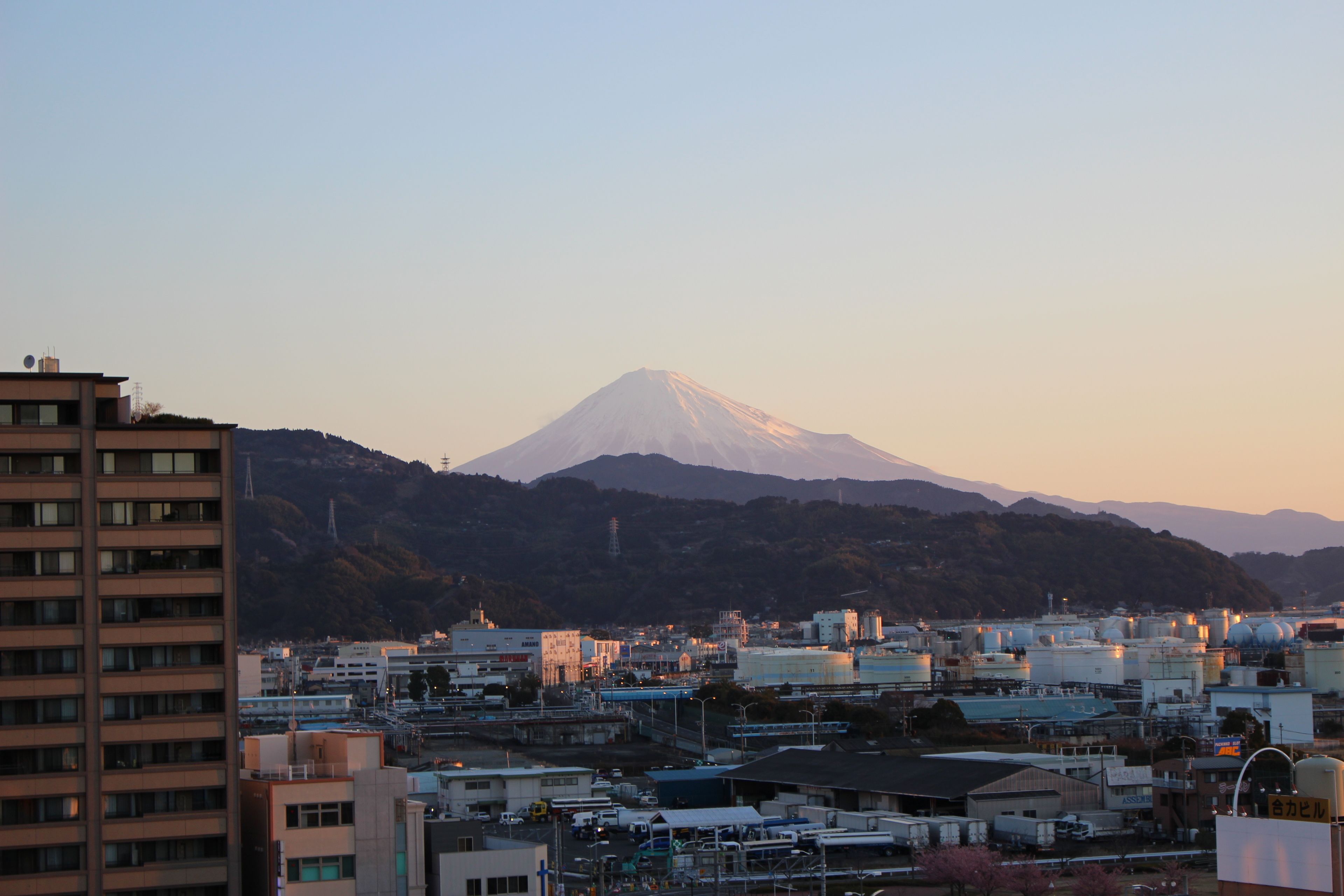 A cityscape with a prominent mountain in the background.
