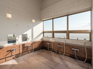 A public restroom with multiple sinks, a large window with a view, and a tiled floor. - Business Hotel Koyo (Aichi)