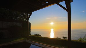 A sunset view from a covered outdoor area with a pool. - Seaside Resort Tsukino Usagi (Ito)