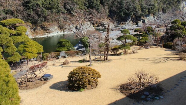 A traditional Japanese garden with a pond, rocks, and various trees. - Hana no Omotenashi Chosei Kan (Nagatoro)