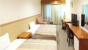 A hotel room with two beds, a desk, a chair, a television, and a window with curtains. - Station Hotel Au (Tsu)