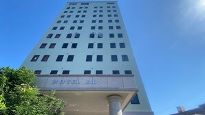 A tall hotel building with a sign reading 'HOTEL AU' at the bottom. - Station Hotel Au (Tsu)